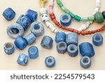 Small photo of Anceint blue glass beads used as everyday items of adornment, ceremonial costumes and objects of barter (trade) from probably 1050 to 1250 AD. Northern Tuli Game Reserve. Botswana