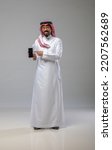 Small photo of A saudi character holding the phone on withe background
