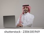A saudi character sites at the desk using laptop with different positions on withe background