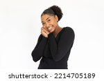 Portrait of admiring young woman posing against white background. African American lady wearing black longsleeve looking at camera with love and excitement. Admiration concept