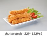 Deep fried shrimp with breadcrumbs in white plate on grey background.