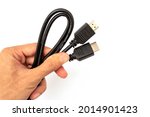 Hand holding hdmi cable on...