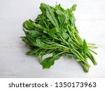Small photo of Raw green living cress or watercress leaves bunch on wooden table background. Organic healthy leaves of cress for eat. Garden cress or watercress (Lepidium sativum) mustard garden pepper pepperwort