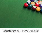 Top view of pool billiards snooker balls on green table with setup position ready for break.