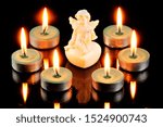 Small photo of Angel messenger, with wings and bright candles around. In religions, it is a spiritual, incorporeal being who communicates the will of God and has supernatural powers. The candle is a symbol of life.