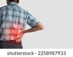 Small photo of Asian elder man suffering from right sided low back and loin pain. It can be caused by mechanical or pathological process.