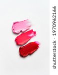 Small photo of Cosmetic smears isolated on white background. Lipstick or lip gloss swatch macro wallpaper. Beauty swash texture. Liquid makeup product closeup. Banner template with copy space
