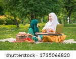 Small photo of Happy Asian family Arabic Muslim mother and little girl child with hijab dress smiling, talking, learning apportion and having fun moment good time in park. Happy Muslim family mom and child concept.