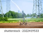 Small photo of Irrigation equipment, irrigation truck on the freshly sown field. Agricultural field irrigation, Irrigation system for irrigating crops, waters the freshly sown field.