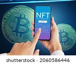 Hand holdding smartphone NFT blockchain on bitcoin cryptographic background marketplace,Cryptoart concept