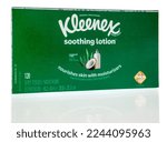 Small photo of Winneconne, WI - 12 December 2022: A package of Kleenex soothing loation facial tissue on an isolated background.