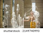 Small photo of Boy having fun in water fountains. Child playing with a city fountain on hot summer day. Happy kids having fun in fountain. Summer weather. Active leisure, lifestyle and vacation.