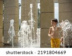 Small photo of Boy having fun in water fountains. Child playing with a city fountain on hot summer day. Happy kids having fun in fountain. Summer weather. Active leisure, lifestyle and vacation.