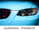 Blue car with headlight, grille and bumper