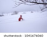 A Child Making A Snowman 