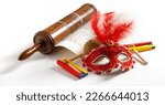 Small photo of The Scroll of Esther and Purim Festival objects (rattles, masquerade mask) on white background.