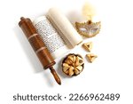 Small photo of The Scroll of Esther and Purim Festival objects (rattles, masquerade mask, Hamantaschen) on white background. Top view
