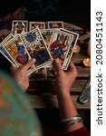 Small photo of Close-up of a fortune teller reading tarot cards