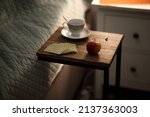 Small photo of An apple, playing cards and a cup on the bedside table. So they guess at the betrothed.