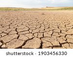 Small photo of Dry and cracked land, dry due to lack of rain, in the Loteta reservoir, near the town of Gallur, Spain. Effects of climate change such as desertification and droughts.