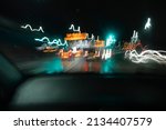 Small photo of Blurred and shaky traffic and car lights captured by long exposure photography on a night road trip in England