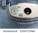 Cash money and smart phone in blue jeans pocket -concept of young small online business owner in a social media technology wireless internet world.