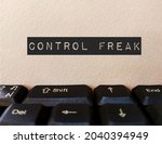Card on keyboard with text CONTROL FREAK ,concept of boss, coworker, manager in workplace ,need to be in charge of things and people around, to make sure everything goes their ways