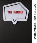 Small photo of Word sticker on black background with copy space , with text TRY HARDER , concept of self motivation to never give up, being persistent and work harder do better , develop winner attitude or mindset.