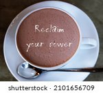 Small photo of A cup of hot chocolate with handwritten text Reclaim Your Power, self talk affirmation to encourage people who tired of feeling stuck in career or relation to reclaim power and reinvent their life
