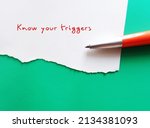 Small photo of On green copy space background, pen writing on torn paper KNOW YOUR TRIGGERS, learning to know experience of having emotional reaction to a disturbing topic in media or social setting and cope with it