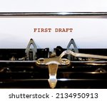 Small photo of Vintage typewriter with white blank paper typed FIRST DRAFT, concept of a rough draft or very first version of of writing piece - sketch of what writing work will be like
