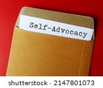 Small photo of Documemt paper in envelope on red background with text SELF ADVOCACY means ability to speak-up for yourself, able to ask for what you want and tell people thoughts and feelings
