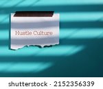 Small photo of Stick note on blue background with text HUSTLE CULTURE - lifestyle where career has become frirst priority in life, state of constant overworking to the point where it becomes lifestyle