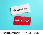 Small photo of Torn paper on blue copy space background with handwriting BEING NICE, changed or BEING KIND, to stop being People Pleaser, prioritize self-respect and stop seeking validation with niceness