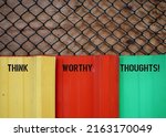 Small photo of Colors wall with handwritten text inscription Think Worthy Thoughts!, means learning to control thoughts and overcome negativity to gain courage, conquer fear and boost self worth