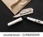 Small photo of Torn office envelope and pen writing word BROWNOUT, Employees feel overworked, demotivated and disengaged – which is essentially the stage before burnout