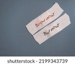 Small photo of Plaster adhesive bandages on gray background with handwritten text BROWNOUT and BURNOUT, concept of brownout syndrome which workers feel overworked, demotivated and disengaged – stage before burnout