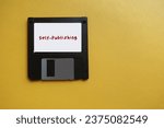 Small photo of Floppy disk on yellow copy space with text SELF-PUBLISHING, act of writer publish piece of creative work book media independently at own expense, without the use of traditional publishing house