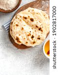 Small photo of Homemade Roti Chapati Flatbread on gray concrete background top view. Freshly baked indian flatbread. Copy space for text.