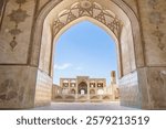 View through the arch of the buildings of the historical Agha Bozorg mosque in Kashan, Iran. building was constructed in late of 18th century