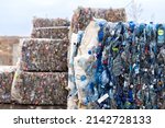 Small photo of 11.18.2021 Vinnytsia, Ukraine. Pressed plastic bottles at a thorough waste sorting station. Briquettes of flattened and bound empty bottles for recycling.