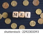 Small photo of The acronym MEI stands for Individual Microentrepreneur written on wooden dice with Brazilian coins in the composition.