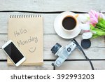 Hello Monday - Coffee with smartphone,camera on wooden table.