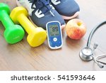 Sport shoe with glucose meter,stethoscope,fruits and dumbbells for using in fitness, concept of diabetes, Exercise in Diabetes Patients concept.