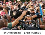Small photo of Kiev/Ukraine - 07.27.2020:young man journalist and reporter with professional video camera work inside crowd of people at street protest action: movement against capitulation.Reportage editorial photo