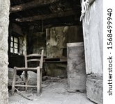 Small photo of What looks like the kitchen of an abandoned house, with a chair in plain sight, marked by the inexorable flow of time