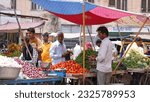 Small photo of Beawar, Rajasthan, India, July 1, 2023: Indian customers haggle for prices before buying tomato at a market in Beawar. Vegetable prices have soared across India. Photo: Sumit Saraswat