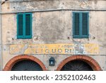 Small photo of Castagneto Carducci, Livorno, Tuscany, Italy - 06 20 2023: The faded sign of the historic liquor distillery "Emilio Borsi", founded in 1800 and frequented by the Nobel Prize poet Giosue Carducci