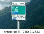 Small photo of Chamonix, Haute-Savoie, Auvergne-Rhone-Alpes, France - 07 29 2023: Sign on the Highway 205, or the Route blanche (White Route) due to its snowiness, with the directions to the Mont Blanc Tunnel