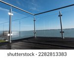 Small photo of View of the lake from the hotel's terrace with a glass railing